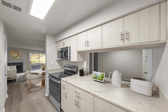 Kitchen with stove top oven at Cloverset Active Adult Apartments, Missouri, 64114