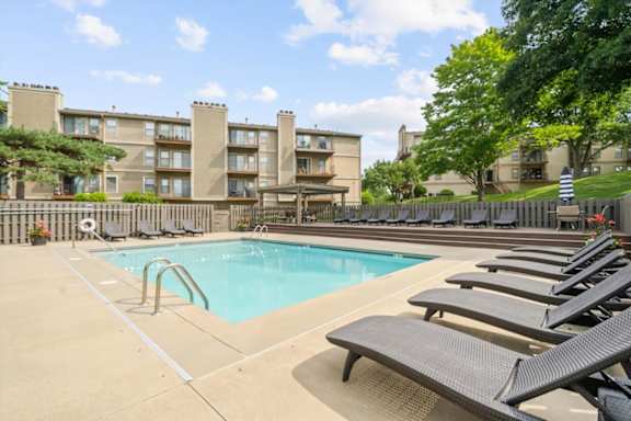 Lounge chairs by the pool at Cloverset Active Adult Apartments, Kansas City, Missouri