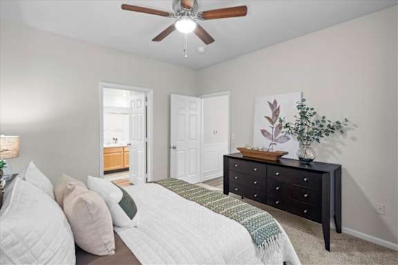 Cozy bedroom with bed and comforter at Deer Creek Apartment Homes, Overland Park, KS, 66213