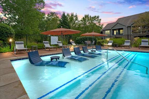 Swimming Pool with Relaxing lounge chairs at Stonepost Ranch Apartments, Overland Park, 66221