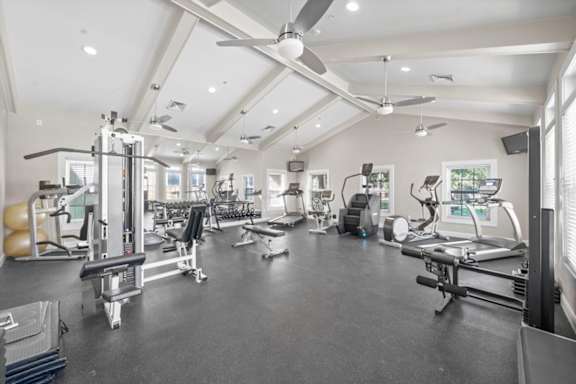 A spacious gym with various exercise equipment and a ceiling fan. at Somerset Oaks Apartment Homes, Olathe, KS, 66062