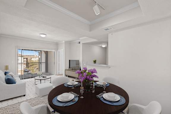 A dining room with track lighting and a patio sliding glass door.