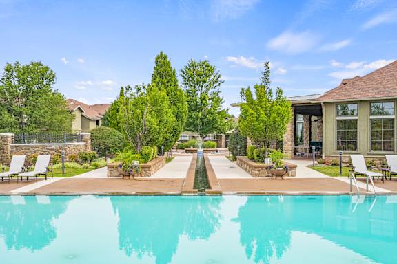 A swimming pool in a residential area with a clear blue sky.
