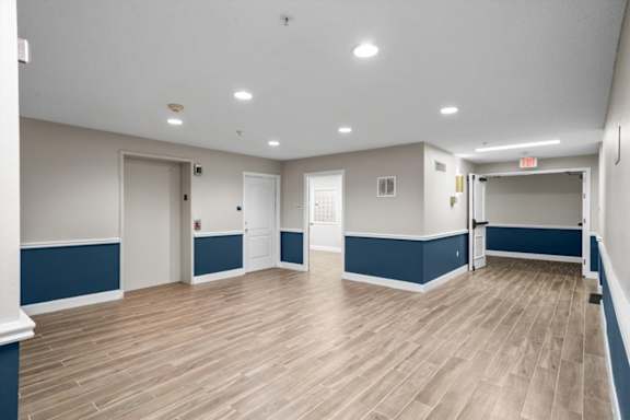 A spacious room with wooden flooring at The Claremont Apartment Homes, Overland Park, 66210