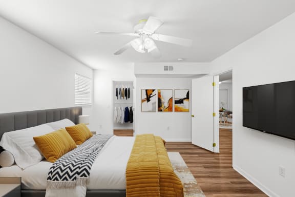 a bedroom with a large bed and a ceiling fan