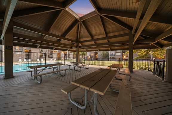 Covered Wooden deck with picnic tables at Bremerton Park Apartment Homes , Prairie Village, KS, 66204