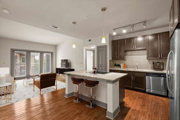 A modern kitchen with a bar area and a dining table.