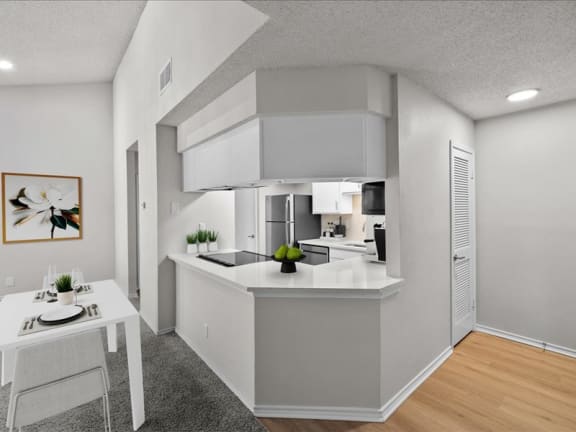 an open kitchen and dining room with a white table