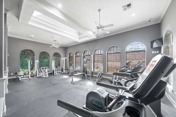 A spacious gym with a variety of equipment and large windows. at Crescent Apartment Homes, Lenexa, Kansas