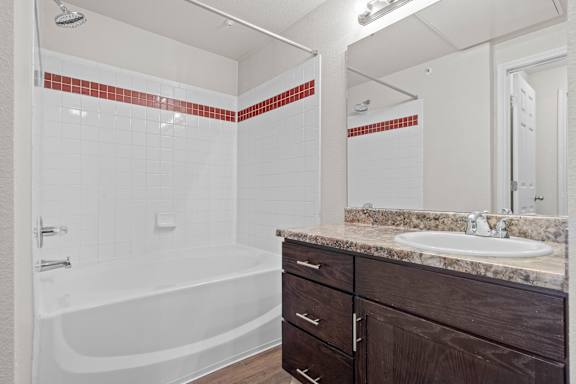 A bathroom with a garden soaking tub and large vanity mirror.