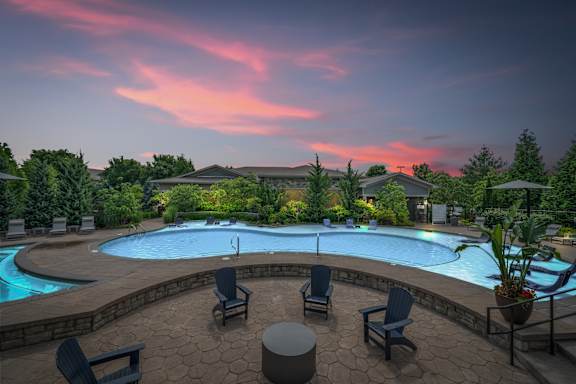 A beautiful outdoor swimming pool area with lounge chairs and a hot tub. at Stonepost Crossing Apartments, Kansas, 66213