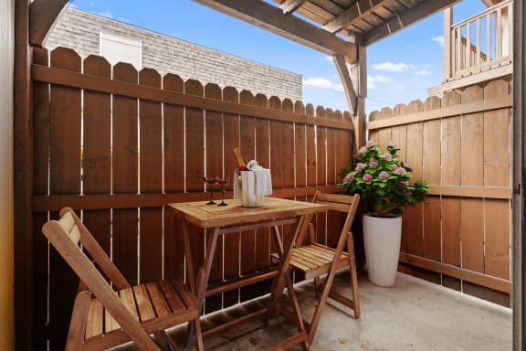 A fenced-in private patio with a concrete base.