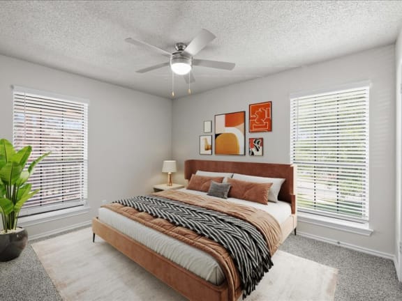 a bedroom with a bed and a ceiling fan