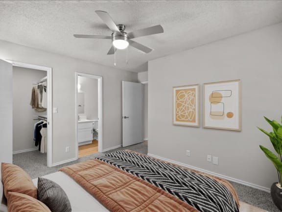 a bedroom with a bed and a ceiling fan