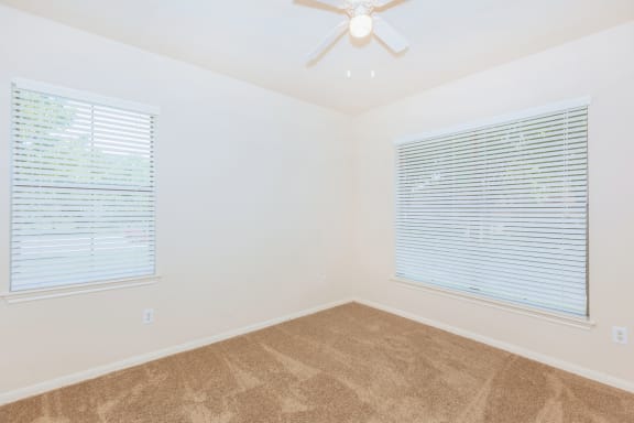 Unfurnished bedroom with window and ceiling fan and lights at Crescent, Lenexa, KS, 66219