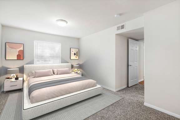 A bedroom with a large bed and a carpeted floor.