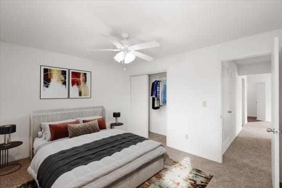 a bedroom with a bed and a ceiling fan at Deerfield Apartments, Olathe, Kansas