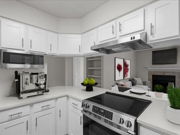 a white kitchen with a stove and a microwave