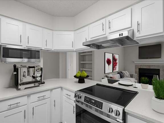 a white kitchen with a stove and a microwave