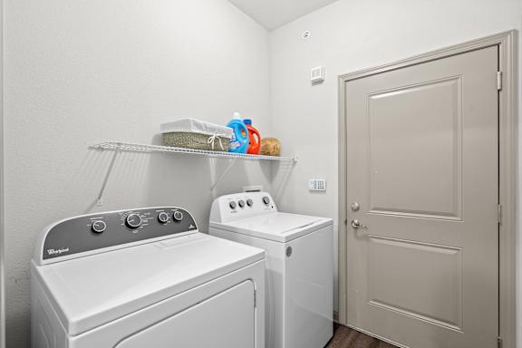 A white washing machine and dryer in a small laundry room.