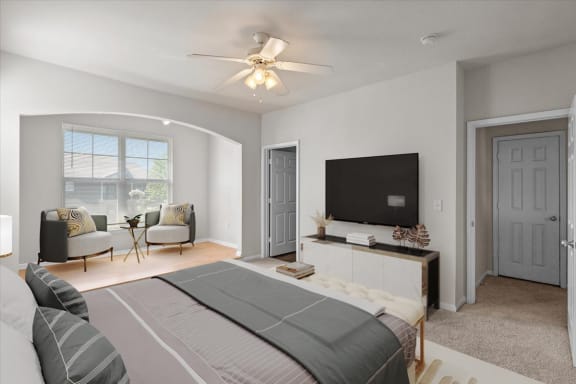 a bedroom with a bed and a ceiling fan