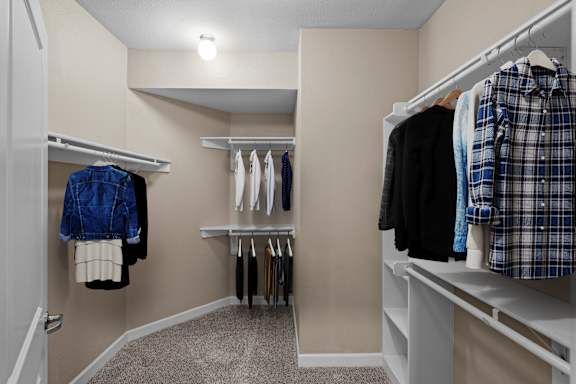 A huge walk-in bedroom closet with built-in shelves, racks, and shoe racks.