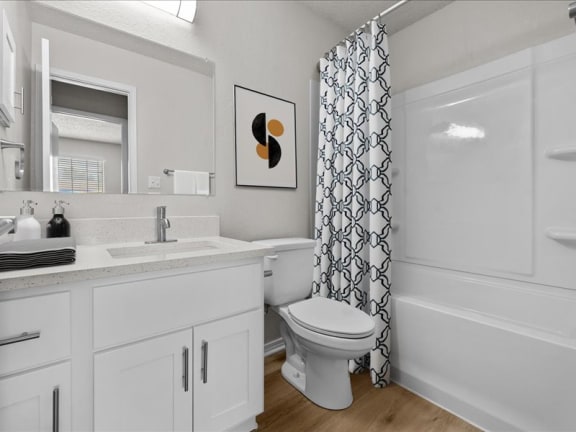 a bathroom with a toilet and a sink and a shower