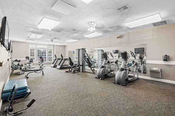 A fitness center with treadmills and other fitness equipment at Stonebriar Apartments in Overland Park, KS.