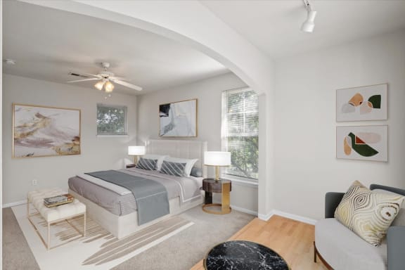 a bedroom with a bed and a ceiling fan