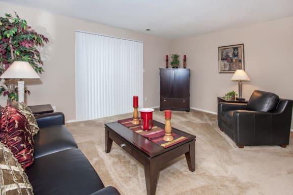Living room with black sofaat Preston Court Apartments, Overland Park, Kansas