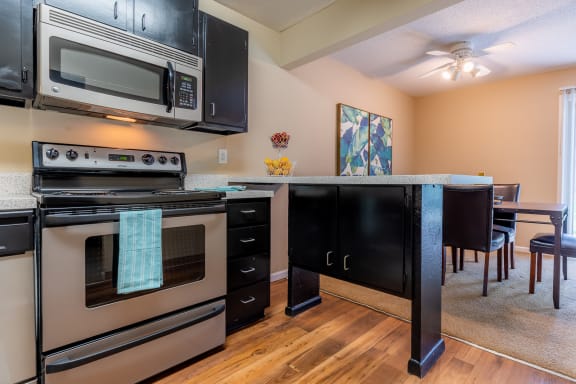 Kitchen with steel appliances and cabinets at Preston Court Apartments, Overland Park, KS