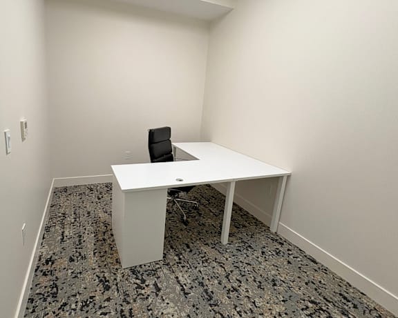 Private workspace at Sky on Main Apartments with a desk and chair for independent work in a quiet environment.