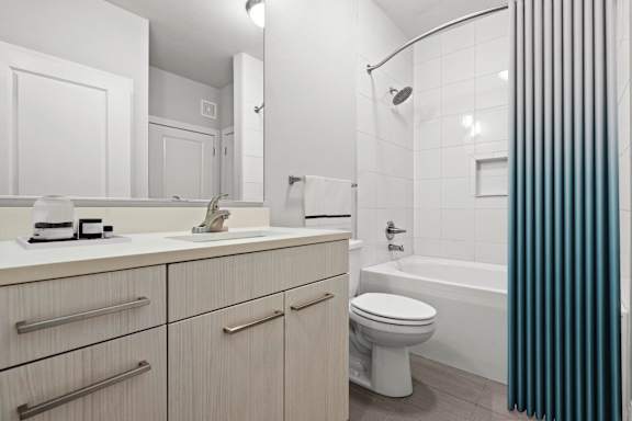 A white toilet sits next to a white sink in a bathroom.