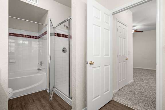 A bathroom with a garden soaking tub and glass sliding door shower.