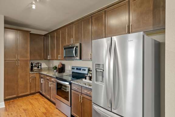 Kitchen with Stainless steel refrigerator and cabinets at The Residences at Bluhawk Apartments, Overland Park, 66085