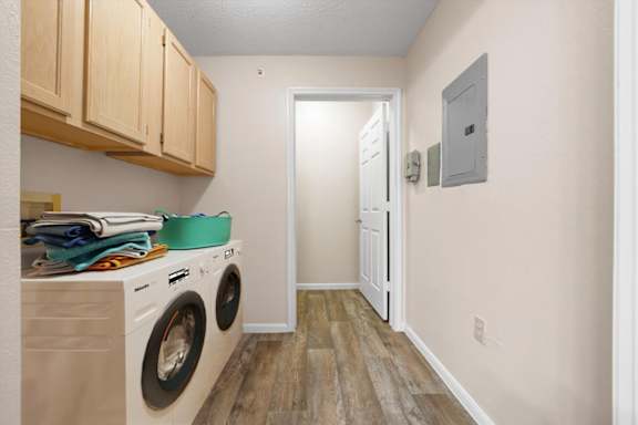 A laundry room at The Claremont Apartment Homes, Overland Park, KS
