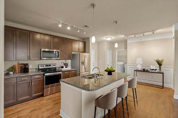 Kitchen with wooden cabinets at The Residences at Bluhawk Apartments, Kansas, 66085