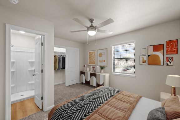 a bedroom with a large bed and a ceiling fan