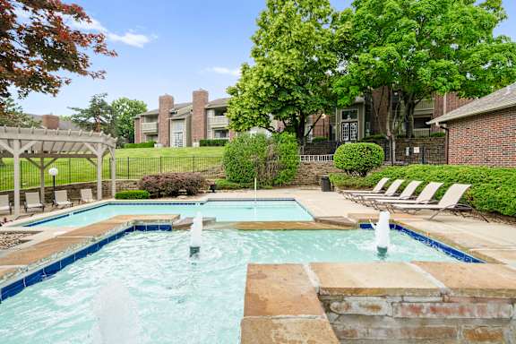 A pool with a waterfall in the middle of it. at Coventry Oaks Apartments, Overland Park, KS