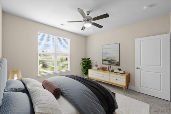 a bedroom with a bed and a ceiling fan