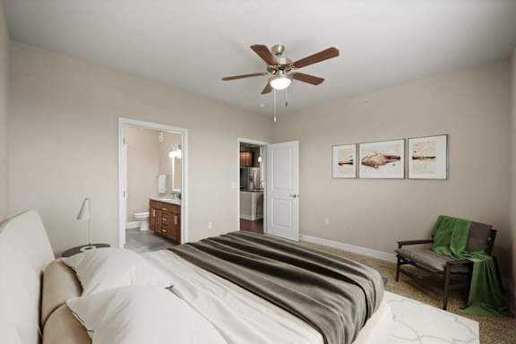 Bedroom with large bed and a ceiling fan at The Residences at Bluhawk Apartments, Overland Park, Kansas