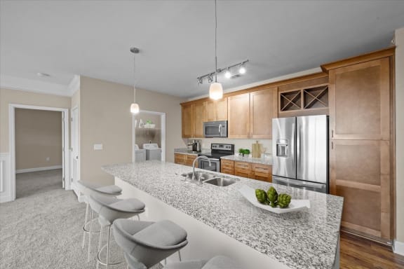 a kitchen with a counter top and a stainless steel refrigerator