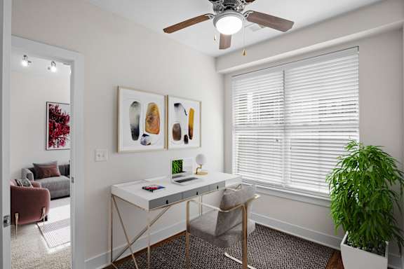 A private study or den with a large window and ceiling fan at West 39th St Apartments in Midtown Westport, Kansas City, MO.