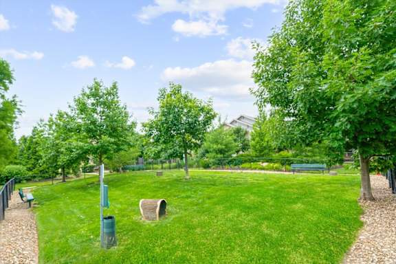 A park with a green lawn and trees. at Stonepost Crossing Apartments, Overland Park, KS