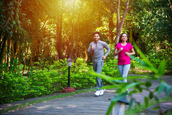 a couple jogging in a park at Stonebriar Woods Apartments, Kansas, 66213