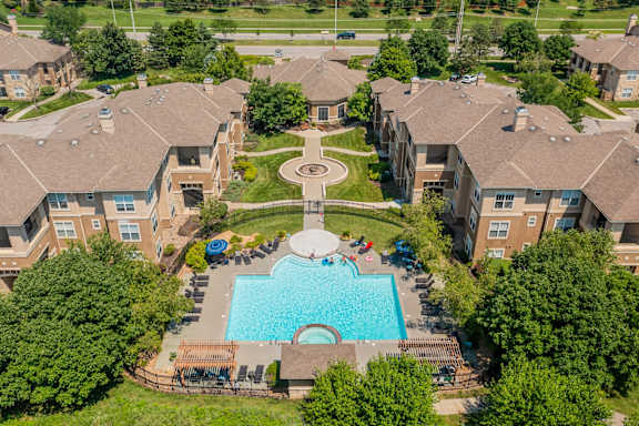 An aerial view of a swimming pool surrounded by houses.