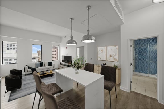 a living room and dining room with a table and chairs