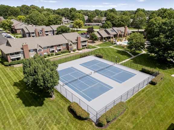 Aerial view of fenced tennis courts at Highland Park Apartment Homes.