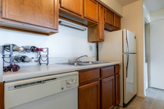 Kitchen with appliances, wooden cabinets, sink and granite counter tops2 at Coventry Oaks Apartments, Kansas, 66214