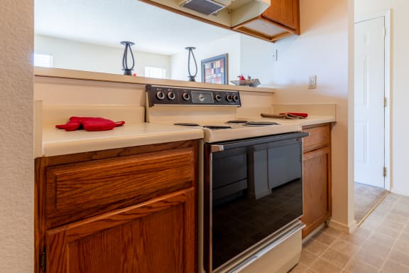 Kitchen with appliances, wooden cabinets, sink and granite counter tops5 at Coventry Oaks Apartments, Overland Park, 66214